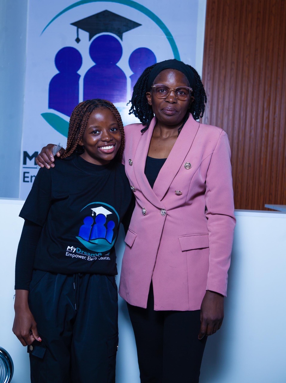 A student and supporter together in front of the MyDreamAdvisor banner