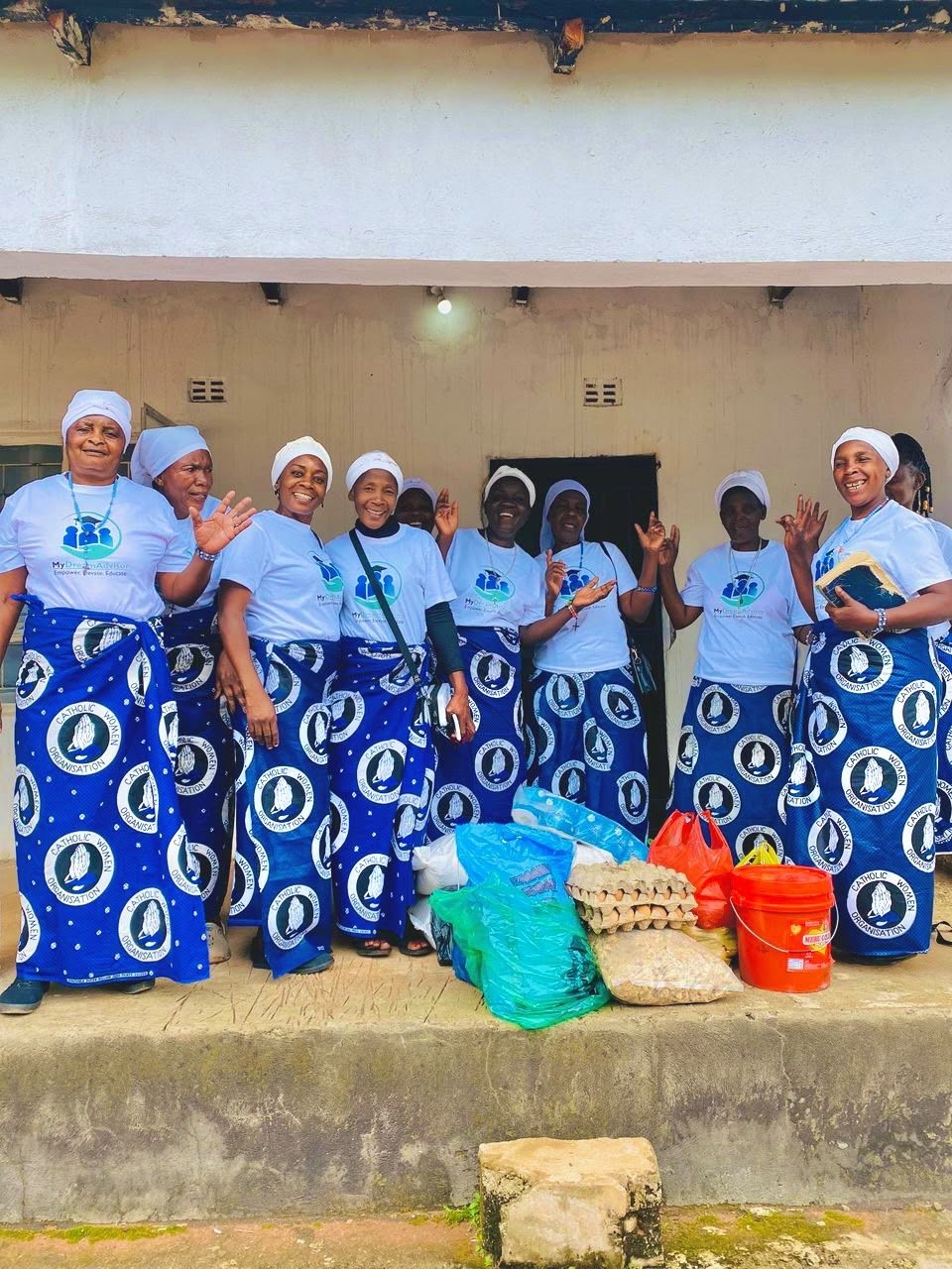 Community members pictured with donated supplies during a MyDreamAdvisor charity visit