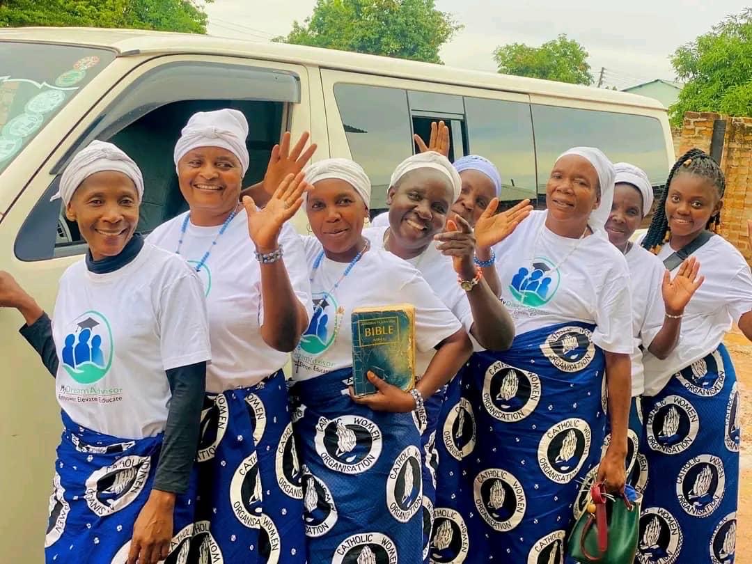 MyDreamAdvisor outreach participants smiling and waving beside a minibus