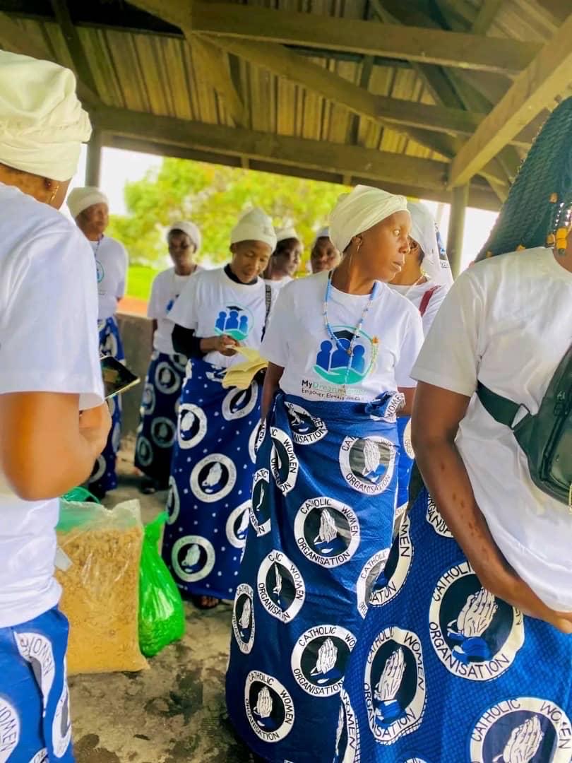 Community outreach participants in MyDreamAdvisor shirts gathered beside supplies